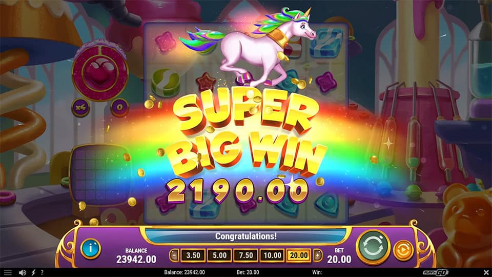 Super Big Win animation in King of Sweets featuring a galloping unicorn and a rainbow burst.