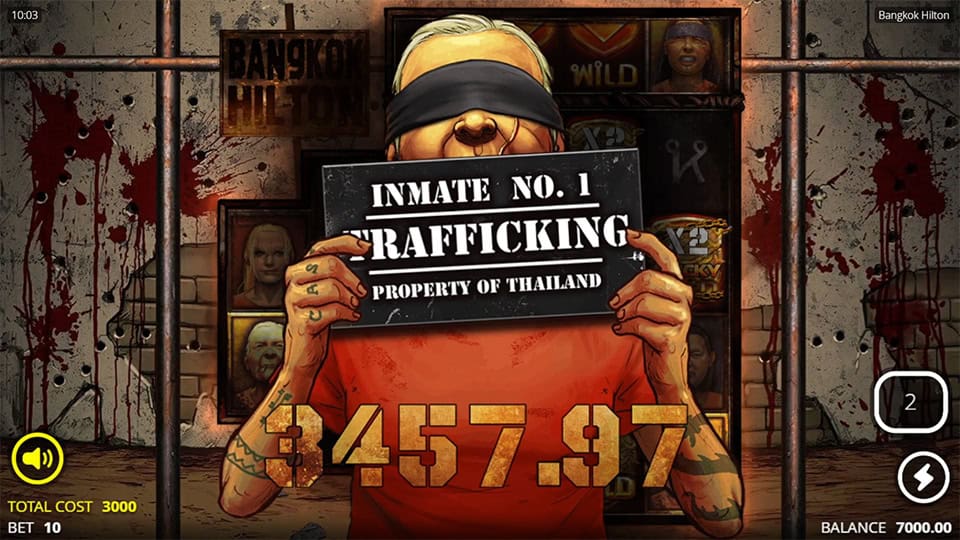 Bangkok Hilton slot win screen showing blindfolded inmate holding a sign reading "Trafficking" with a large golden win display.