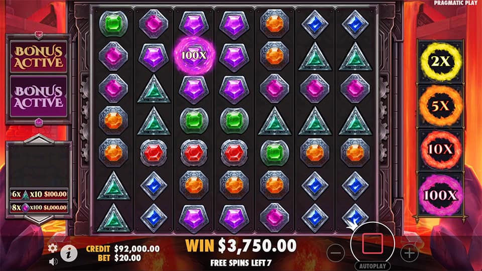 Free spins round showing glowing purple 100x multiplier symbol among other gems.